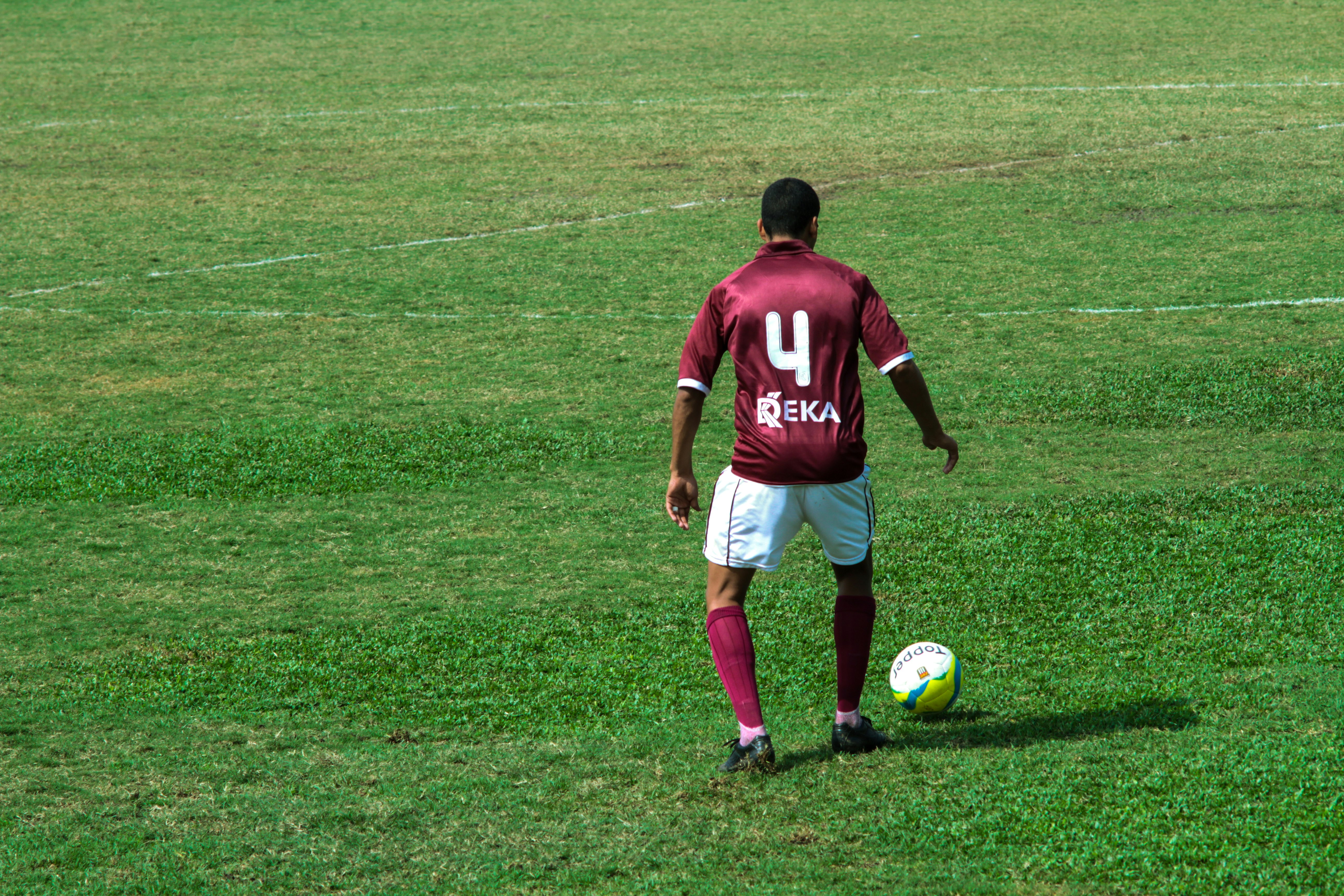 man in blue and white nike jersey shirt and white shorts playing soccer on green grass